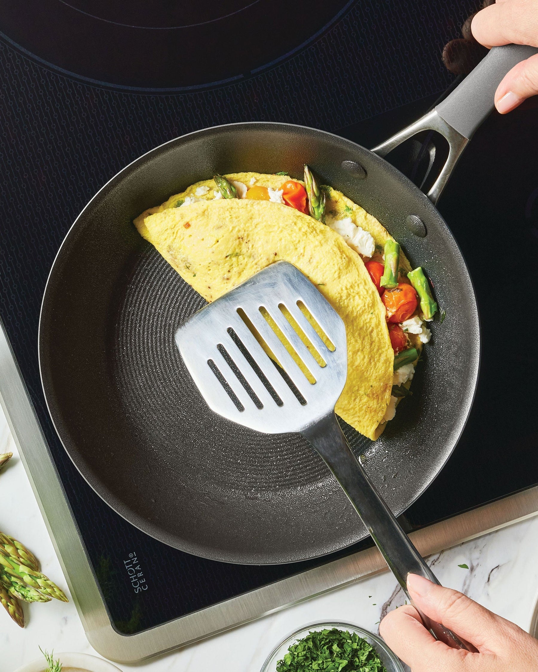 Omelet cooking in a small frying pan. 