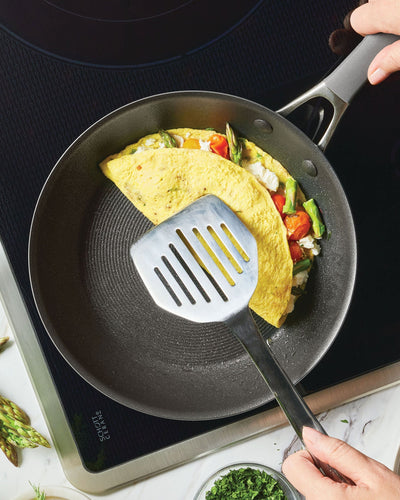 Omelet cooking in a small frying pan. 