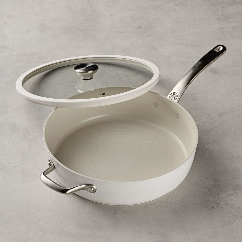 Ceramic Nonstick 5-Quart Sauté Pan with glass lid on a light gray surface.