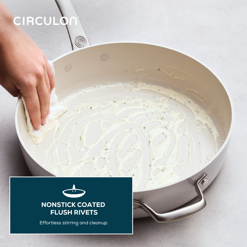 Hand wiping creamy residue from Ceramic Nonstick 5-Quart Sauté Pan.