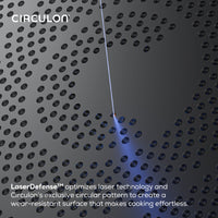 A laser engraves circles on the Ceramic Nonstick 2-Piece Skillet Set.