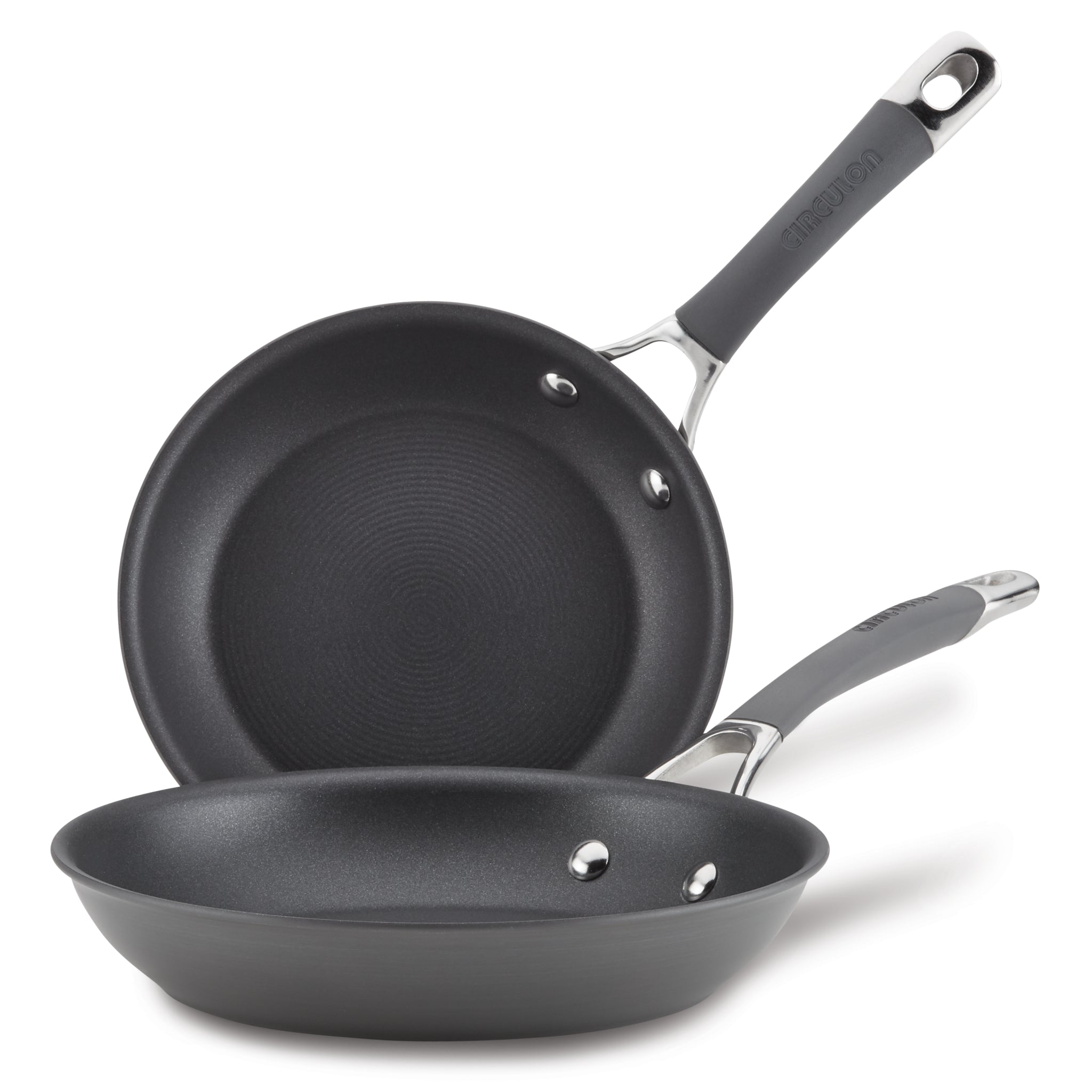 The 2-Piece Nonstick Frying Pan Set includes two black, hard-anodized frying pans with metal handles stacked on top of each other. These dishwasher-safe pans are perfect for any kitchen, offering durability and ease of use without sacrificing quality or style.