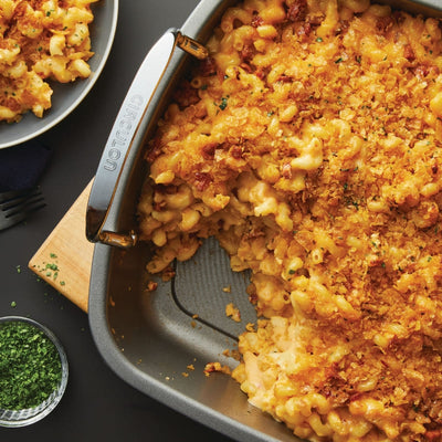 Baked macaroni and cheese with crispy topping in a rectangular baking dish.