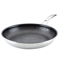 A stainless steel frying pan with a non-stick, circular patterned interior.