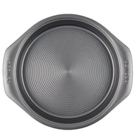 Round non-stick cake pan with handles and a textured base.