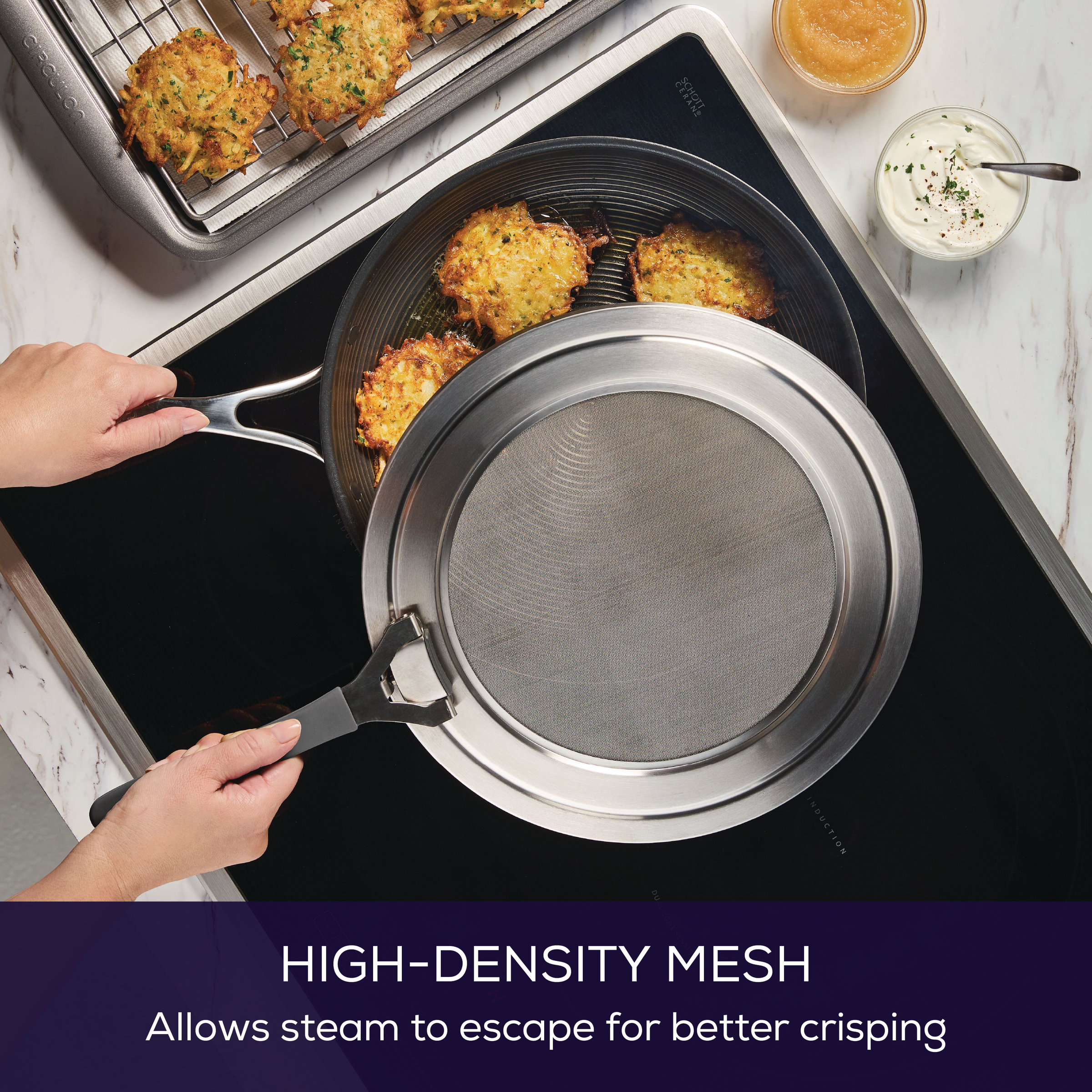 Person holding a Universal Stainless Steel Splatter Guard over food on a stovetop.