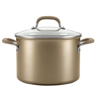 A gold cooking pot with a glass lid and side handles.