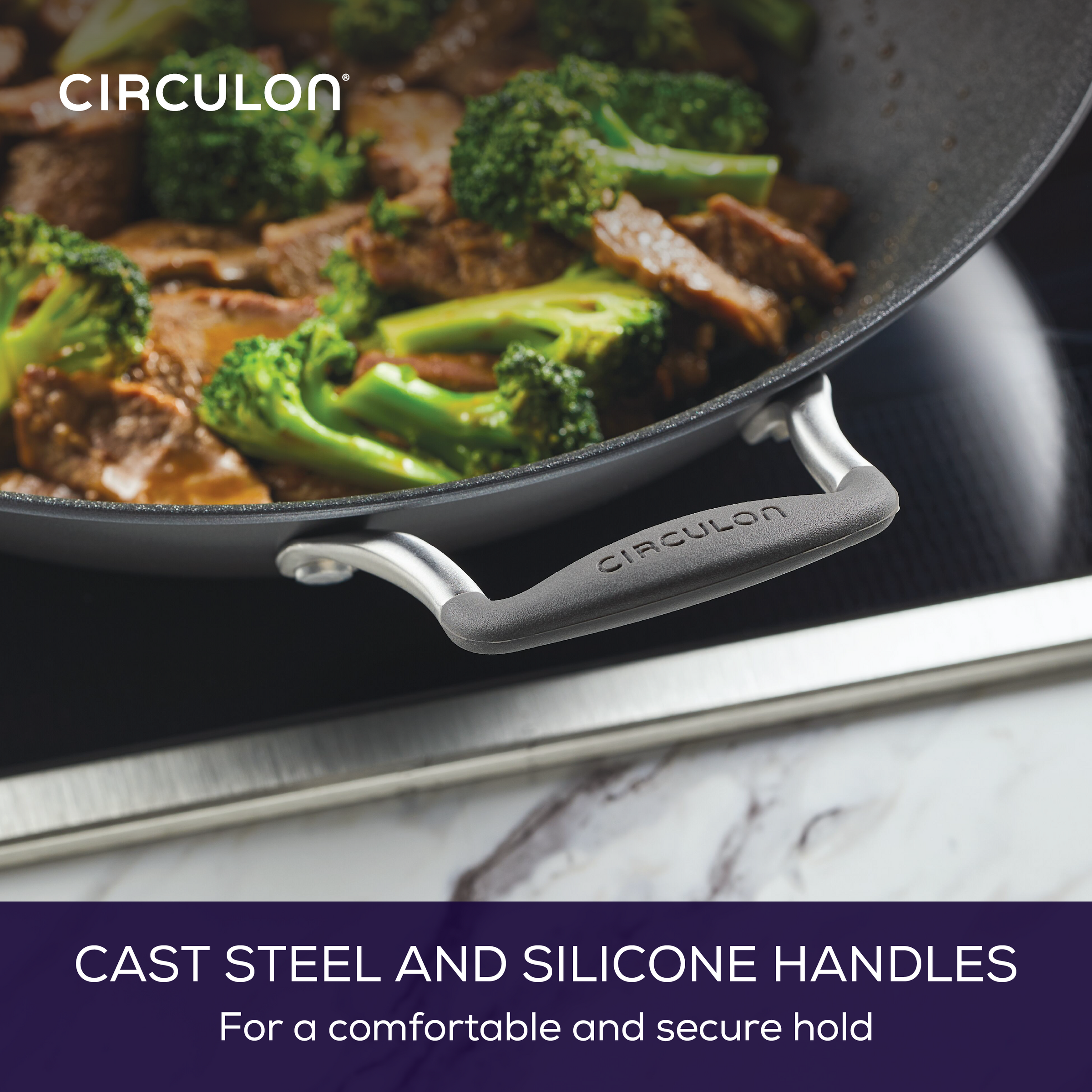 Close-up of a pan with broccoli and meat, featuring cast steel handles.