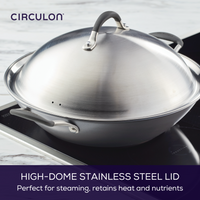 High-dome stainless steel lid on a pan on an induction stovetop.