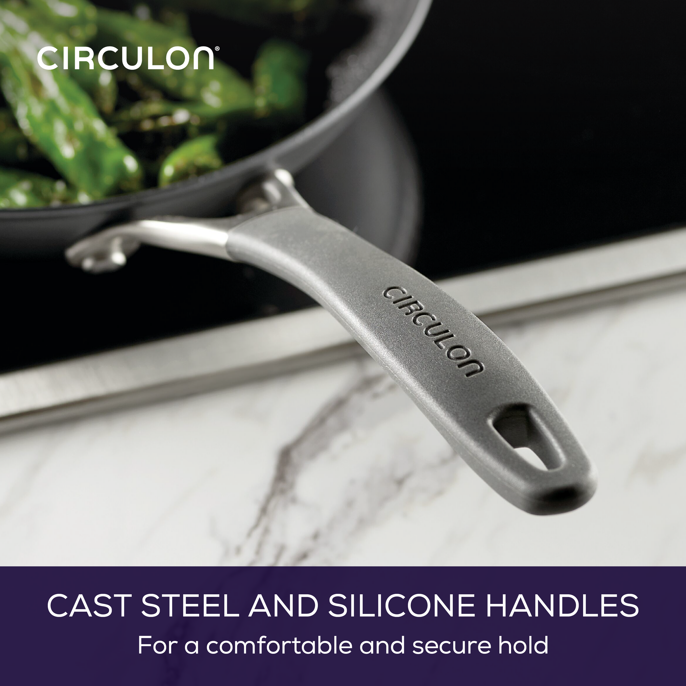 Frying pan with cast steel and silicone handle shown on a stove.