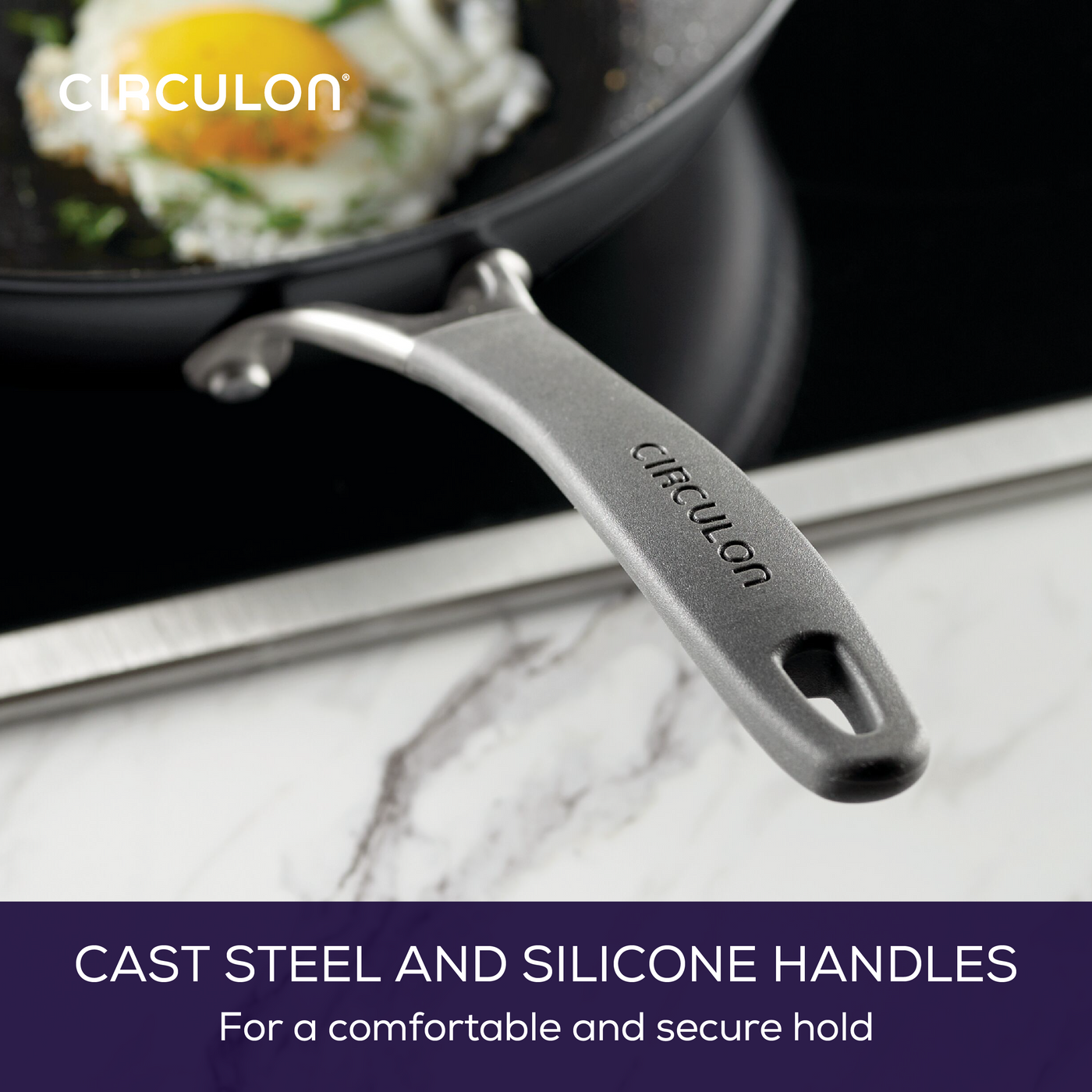A frying pan with a cast steel and silicone handle on a stovetop.