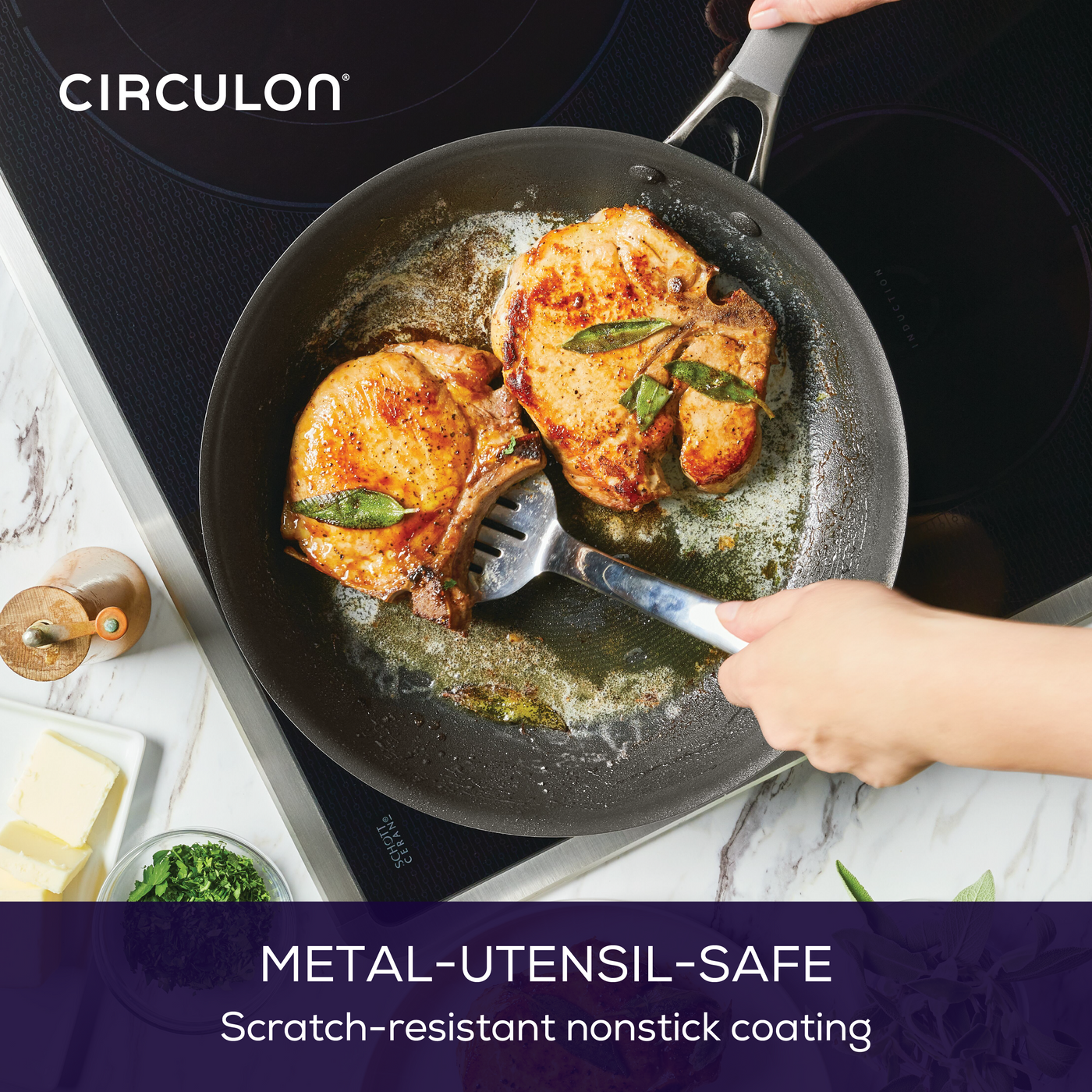 Chicken and herbs frying in a nonstick pan on an induction cooktop.