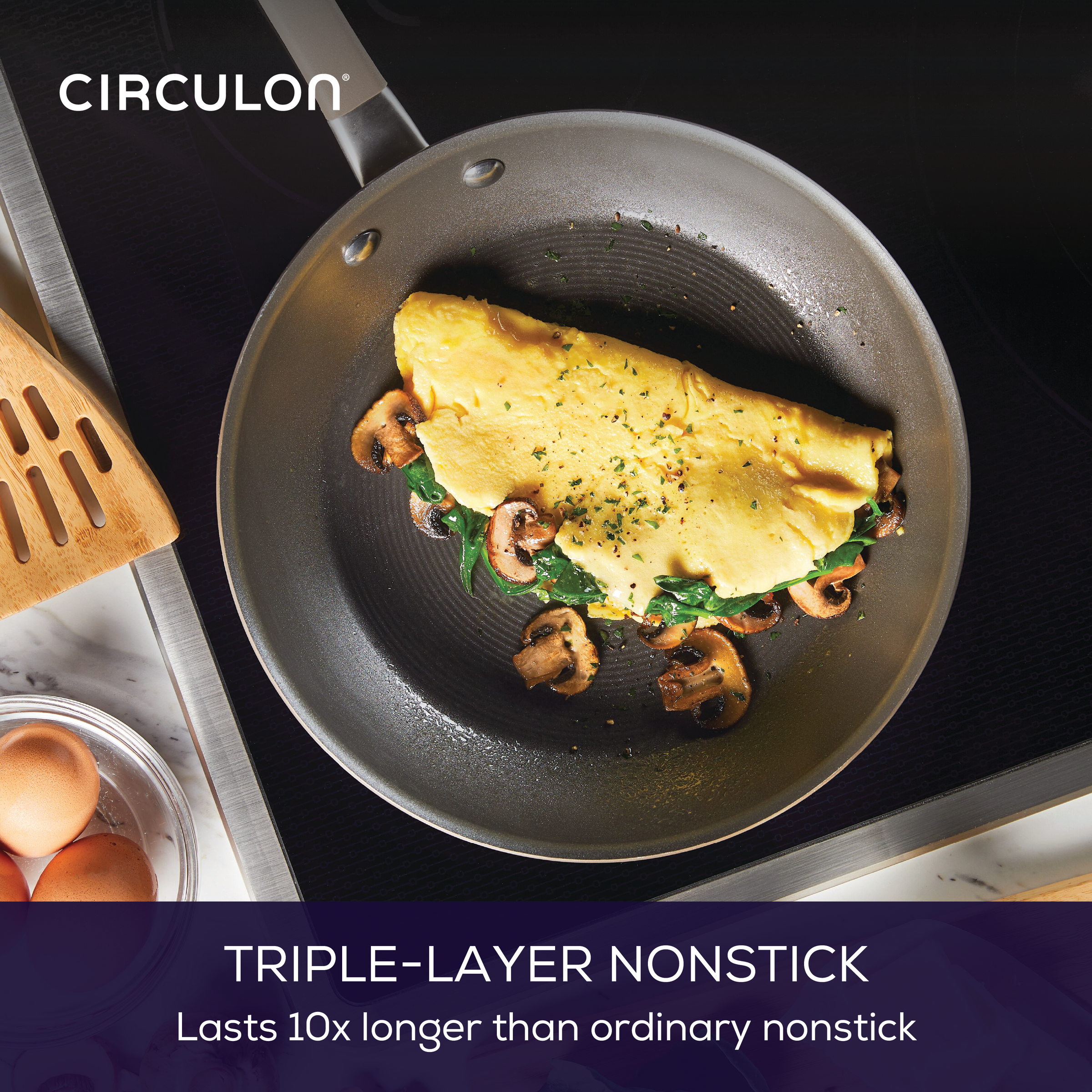 Omelet with mushrooms and spinach in a nonstick frying pan on a stove.