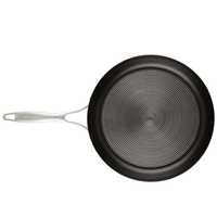 Non-stick frying pan with a silver handle, viewed from above.