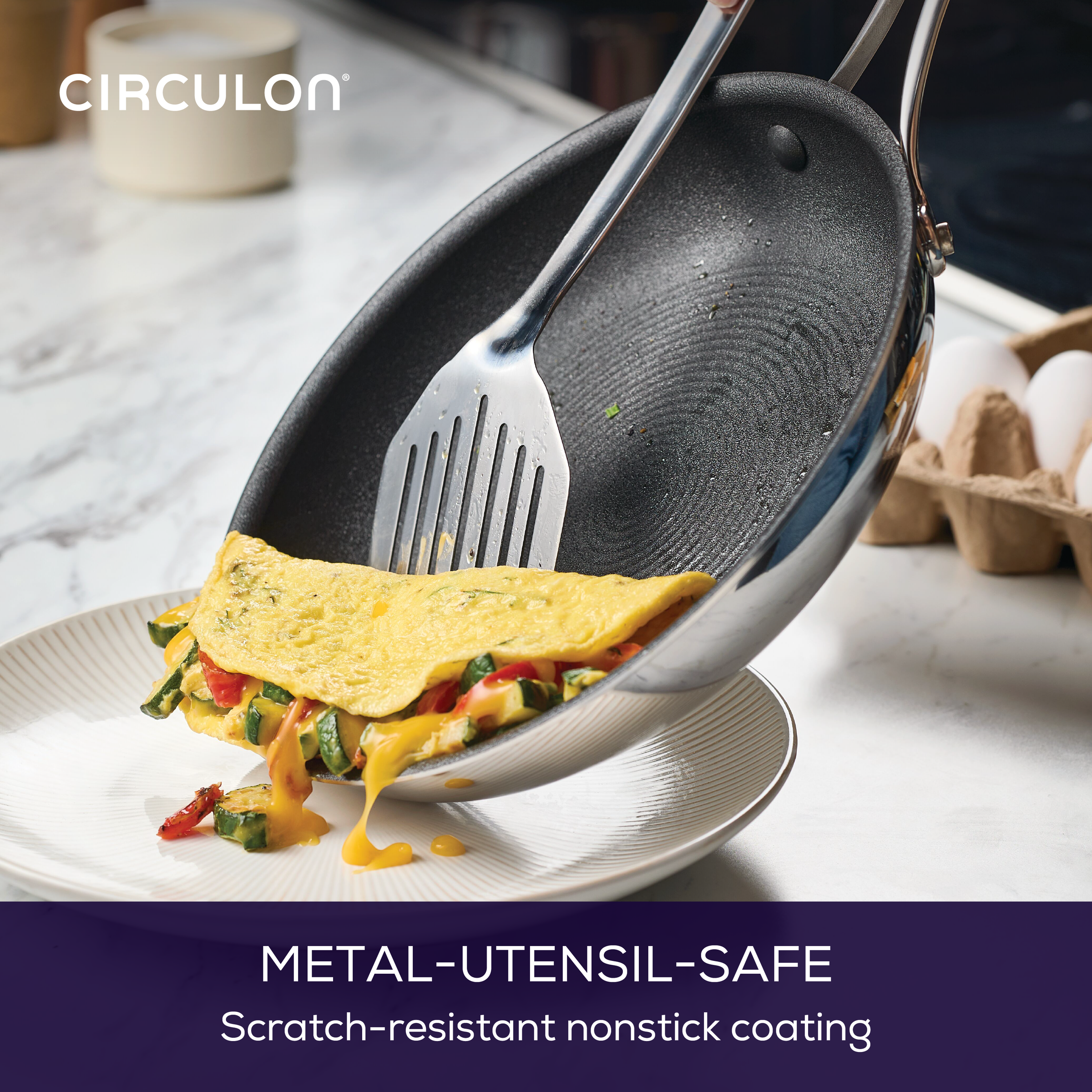 Spatula sliding omelette from nonstick pan onto a plate.