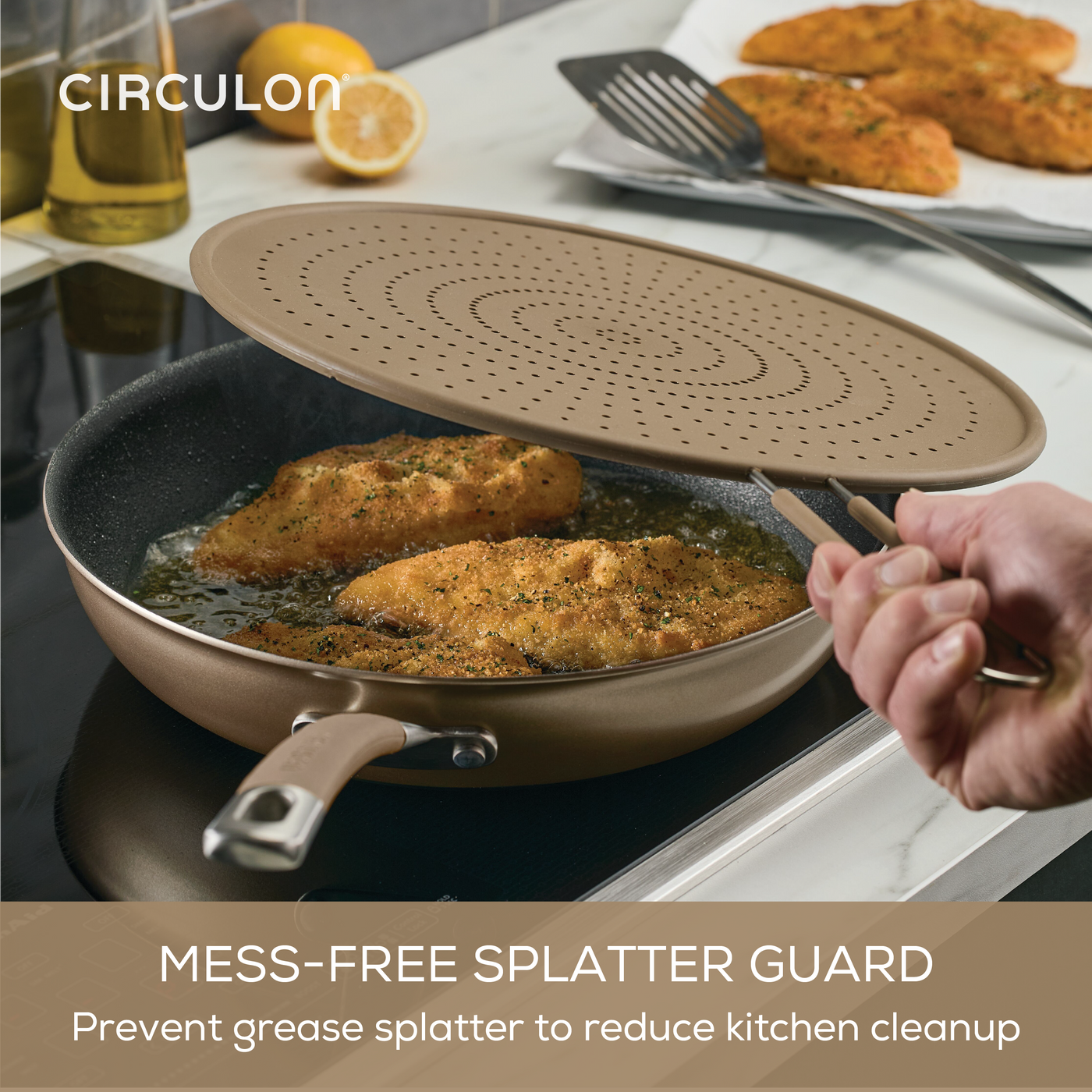 Circulon ScratchDefense splatter guard placed over frying pan with cutlets.