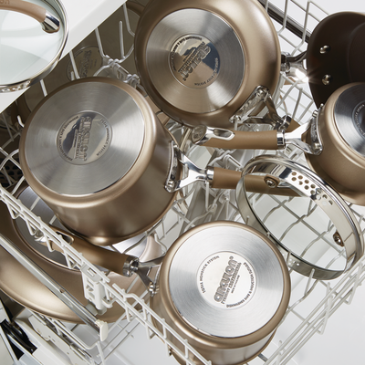 Pots and pans neatly arranged inside a dishwasher.