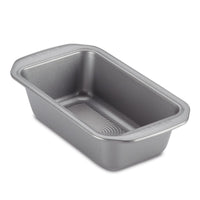 Set of 4 silver rectangular loaf pans, each with a ridged bottom surface and crafted from heavy-gauge steel for enhanced warp resistance, designed in a 9-by-5-inch size.