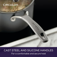 Close-up of a pot with a cast steel handle labeled "Circulon" on a stovetop.