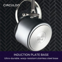 A pot with an induction plate base hanging by its handle.