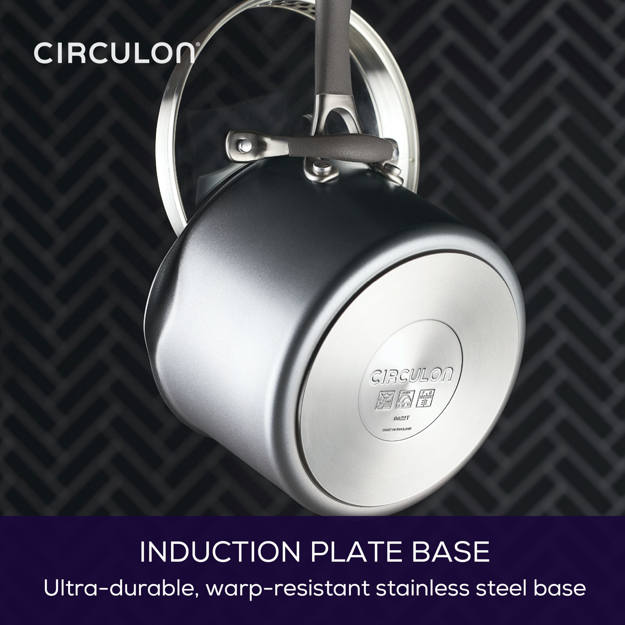 A pot with an induction plate base hanging by its handle.