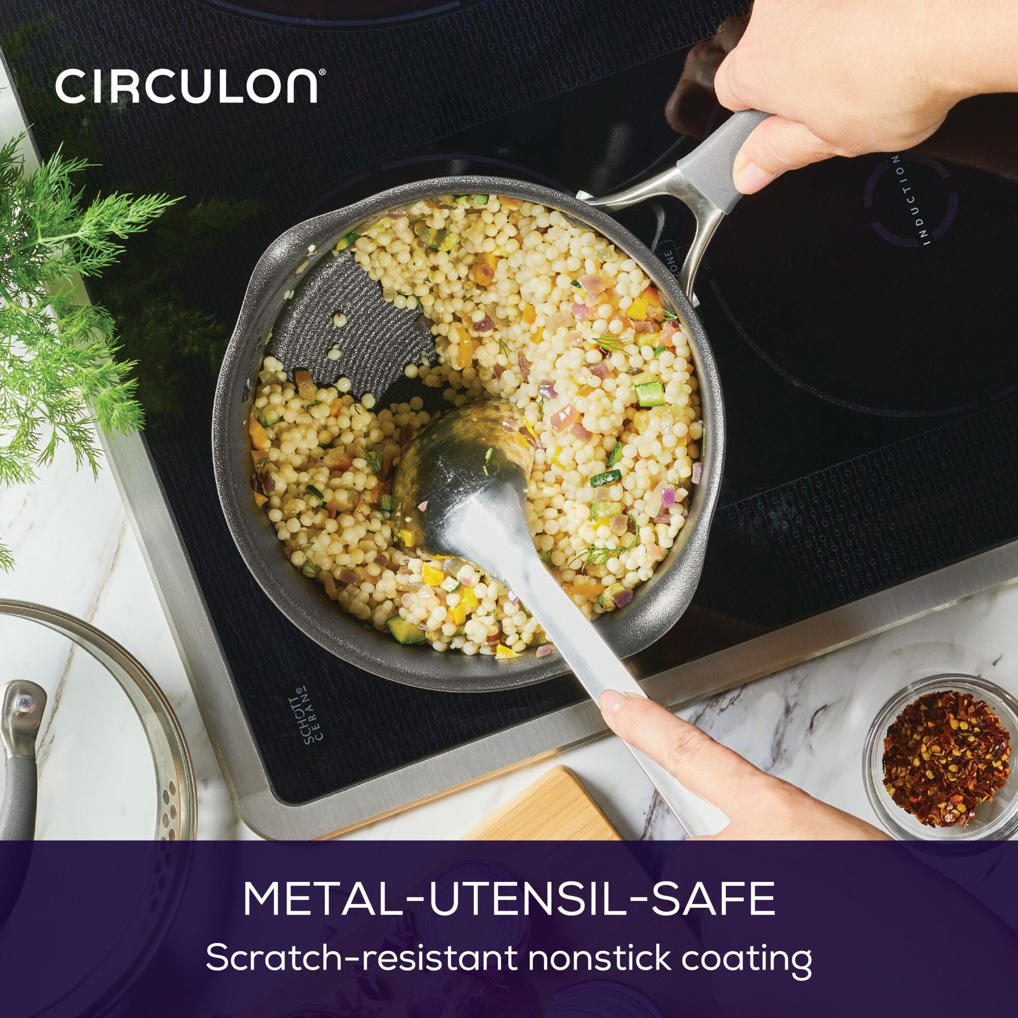 Person stirring couscous in a pan on an induction stove.
