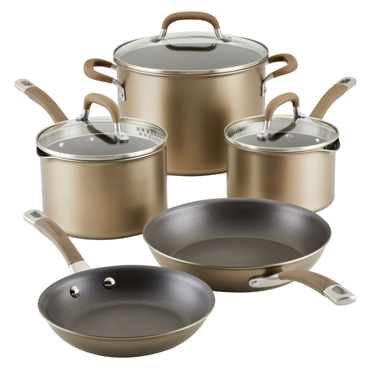 Set of five gold-colored pots and pans with glass lids and handles.