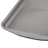 Close-up of a circular textured pan from the Nonstick Bakeware Set marked "Circulon," showcasing an advanced nonstick system for effortless baking.