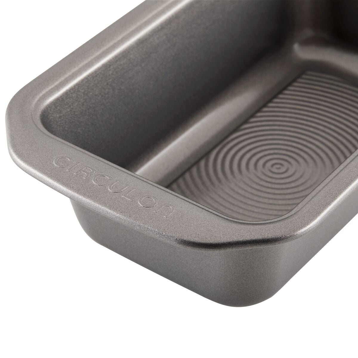 The 9-by-5-Inch Loaf Pans, Set of 4, are gray rectangular pans made from heavy-gauge steel, featuring a textured interior bottom that provides excellent warp resistance.