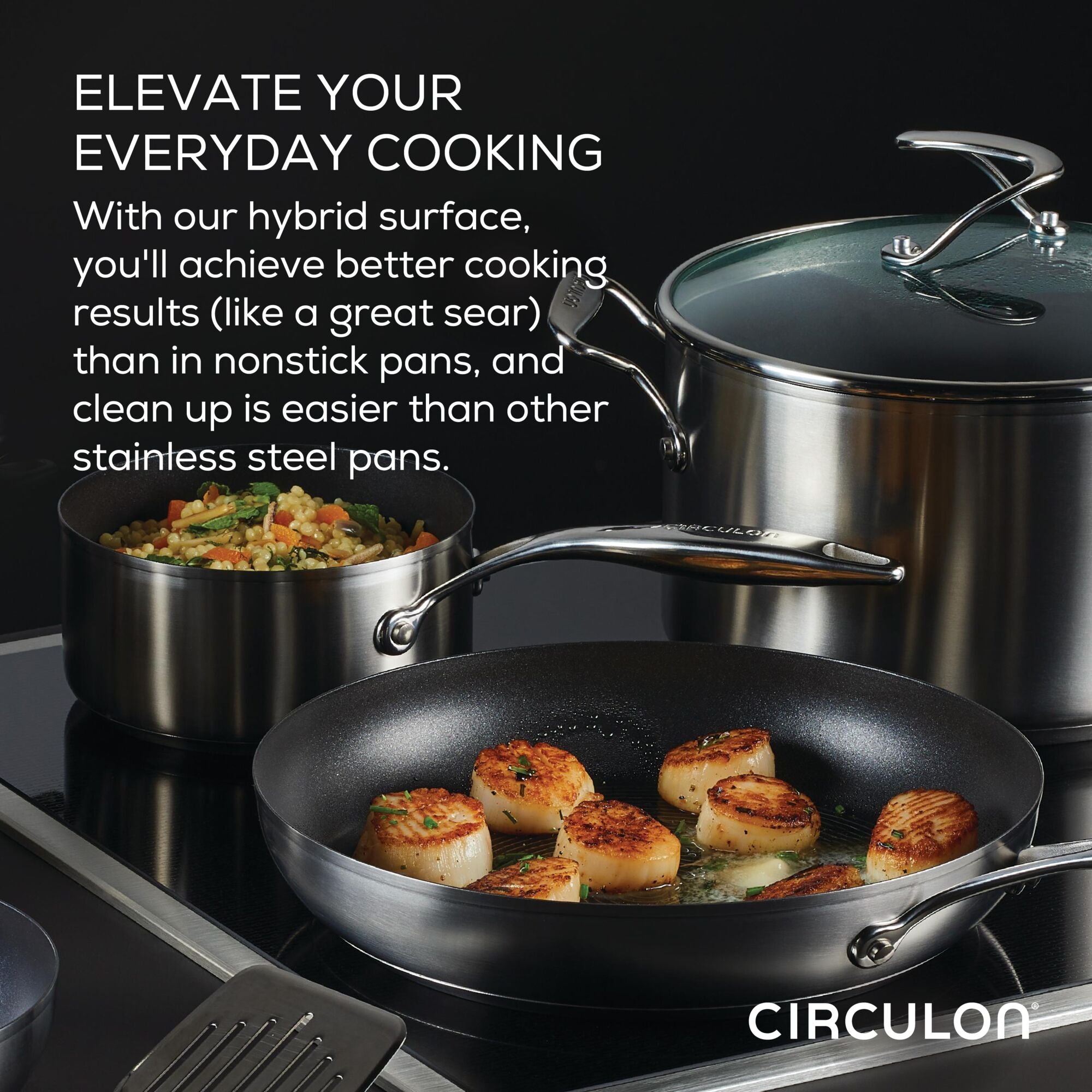 Cookware set with seared scallops and vegetables in hybrid surface pans.