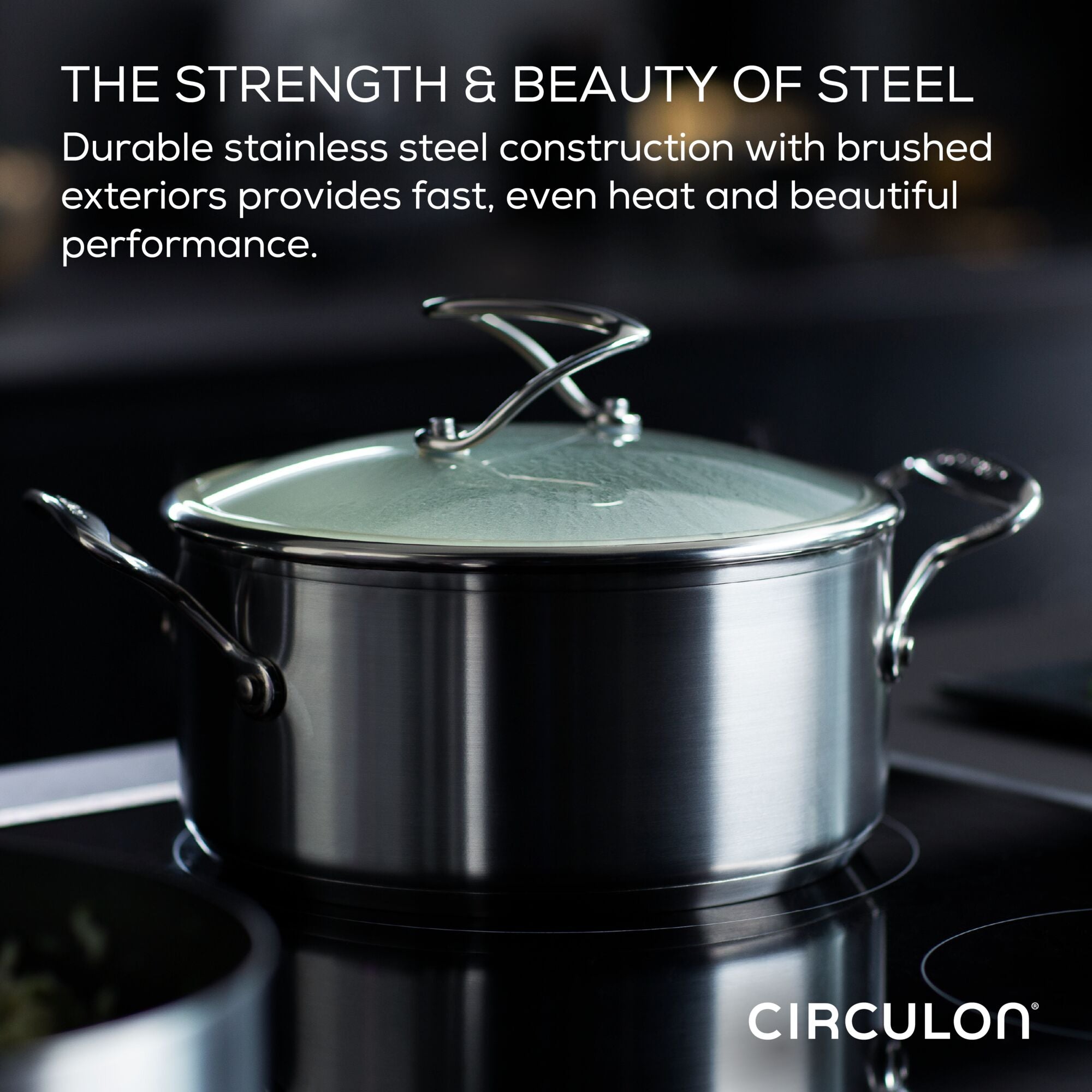 Stainless steel pot with glass lid on a stove, brand name Circulon shown.