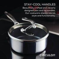 Stainless steel saucepan with stay-cool handles on a stovetop.