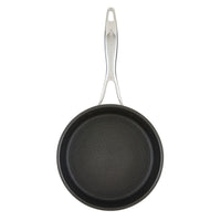 Nonstick frying pan with a ribbed surface and a metal handle.