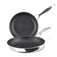 Two non-stick frying pans with metal handles, stacked on top of each other.