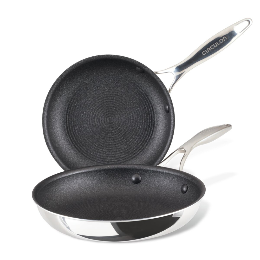 Two non-stick frying pans with metal handles, stacked on top of each other.