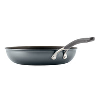 Non-stick frying pan with a dark handle, viewed from the side.