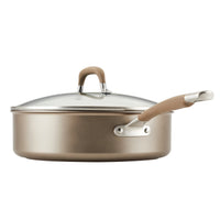 A metal saucepan with a glass lid and a long handle.