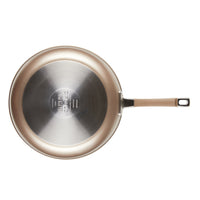 Top view of a stainless steel frying pan with a handle.
