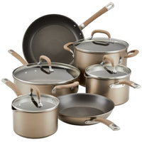 A set of various pots and pans with lids on a white background.