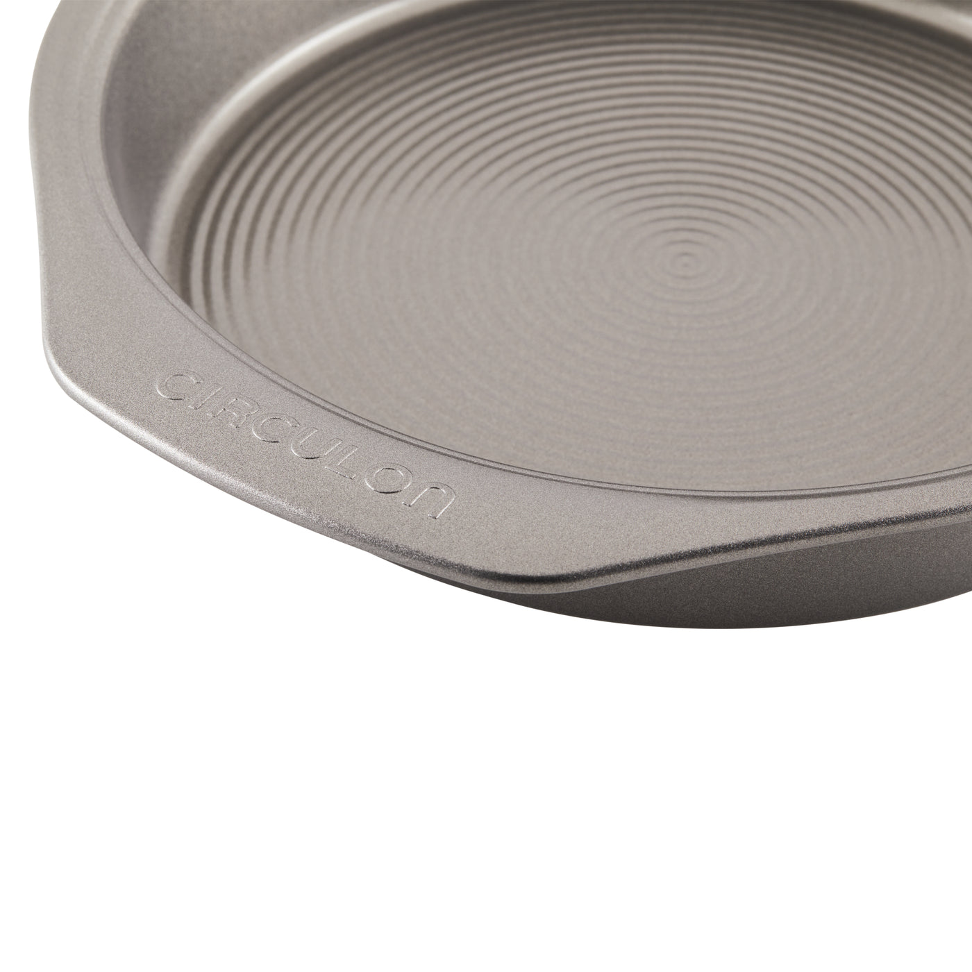 Close-up of a circular non-stick baking pan with ribbed interior surface.