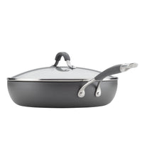 Gray nonstick frying pan with a glass lid and metal handle.