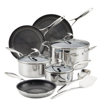 Set of stainless steel cookware with lids and utensils.