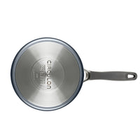 A metal Circulon saucepan with a black handle, viewed from above.