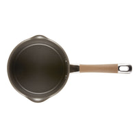 Top view of a small saucepan with a brown handle.