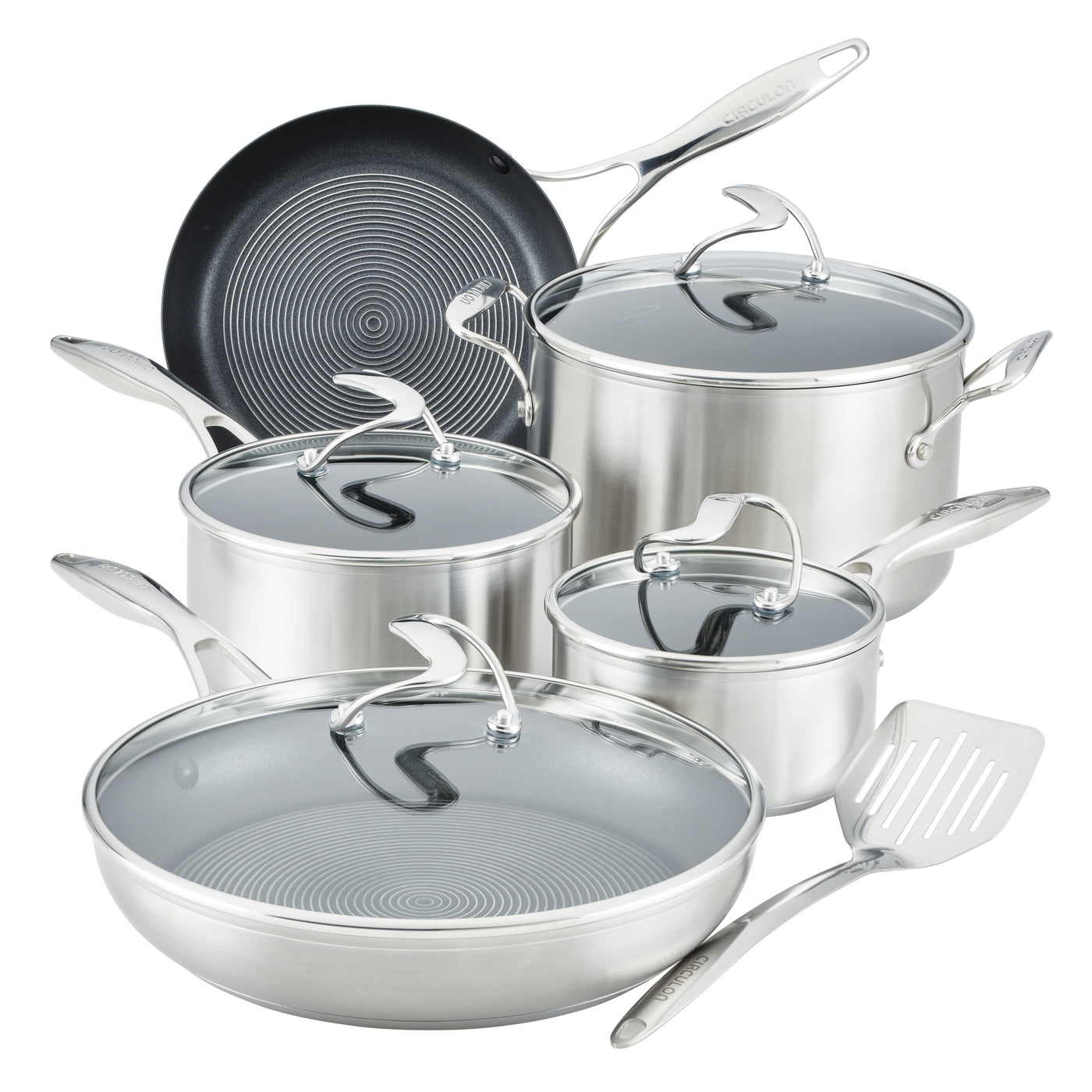 Silver cookware set with glass lids and a spatula.