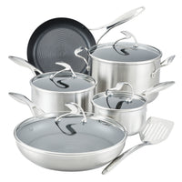 Silver cookware set with glass lids and a spatula.