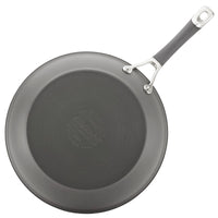 A gray circular frying pan from the 3-Piece Nonstick Frying Pan Set features a metal handle and is crafted from hard-anodized cookware, viewed from above. This nonstick frying pan is dishwasher safe, making cleaning effortless after each use.