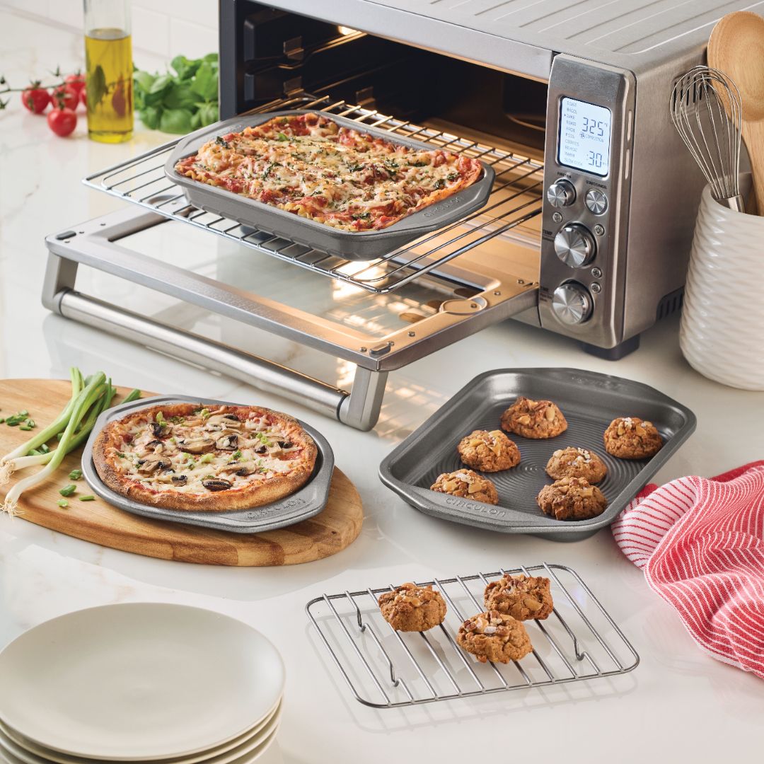 Toaster oven with 4-piece nonstick set for pizza, cookies, and plates.