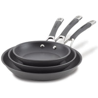 The 3-Piece Nonstick Frying Pan Set includes three nested gray frying pans, featuring silver and black handles, crafted from hard-anodized cookware for effortless cooking. They are dishwasher safe for easy cleanup.