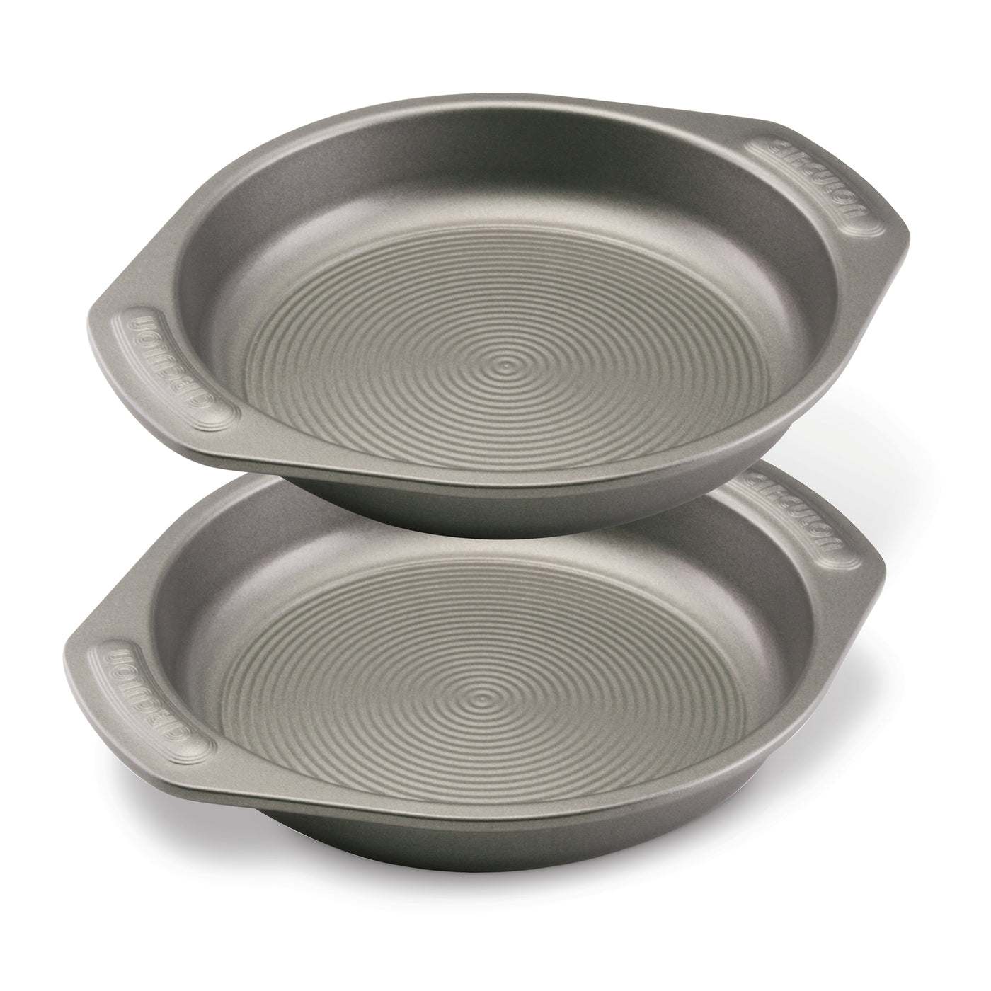 Two stacked round baking pans with handles and textured bottoms.